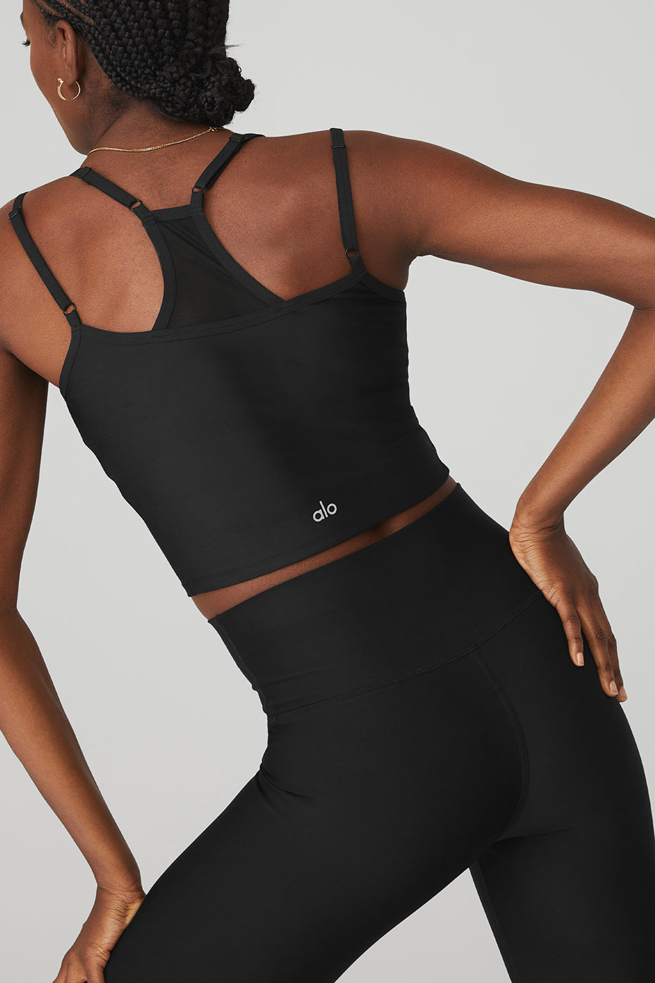 Model showcasing the Airlift Double Check Bra Tank in black, featuring a racerback design and cropped fit.