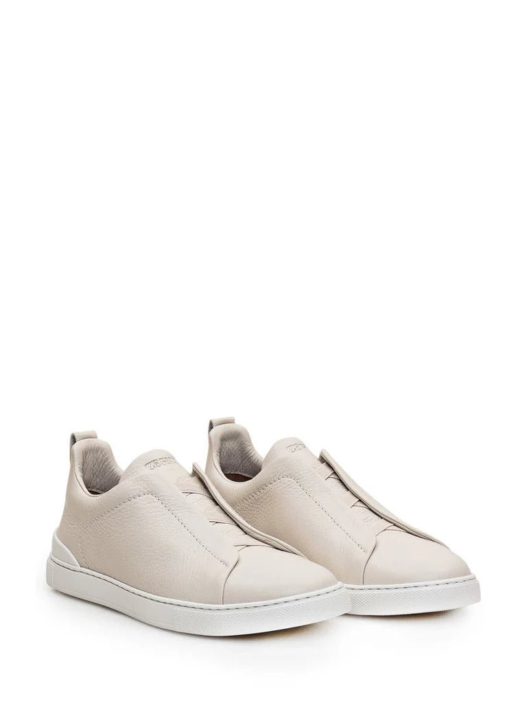 Zegna Men’s Cream Grained Leather Slip-On Sneakers – White Sole, Minimal Design