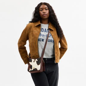 Hadley Mini Crossbody Bag With Cow Print And Tassel