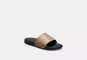 Udele Sport Slide In Signature Canvas slide sandal in coated canvas with classic C pattern and rubber sole.