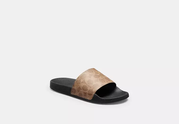 Udele Sport Slide In Signature Canvas slide sandal in coated canvas with classic C pattern and rubber sole.