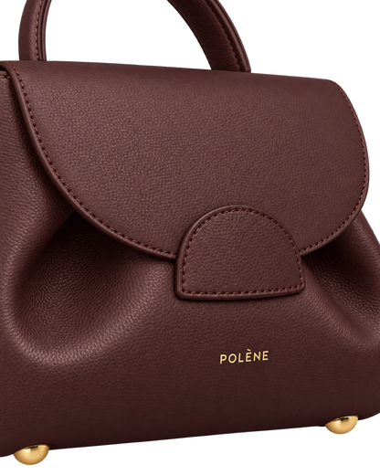 [AI-GENERATED:MACRO_DETAIL] Numéro Un Nano Edition Textured Burgundy — Macro Detail