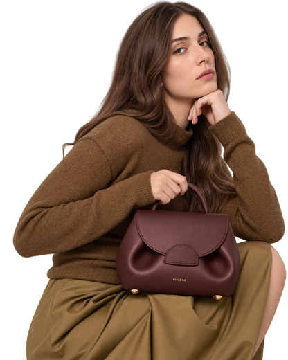[AI-GENERATED:MODEL_SECONDARY] Numéro Un Nano Edition Textured Burgundy — Human Model — Second Pose