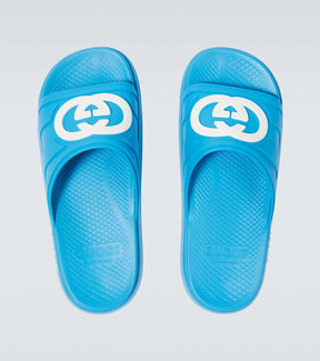 Gucci Pursuit Interlocking G slides in blue with white logo, featuring moulded rubber for comfort and durability.