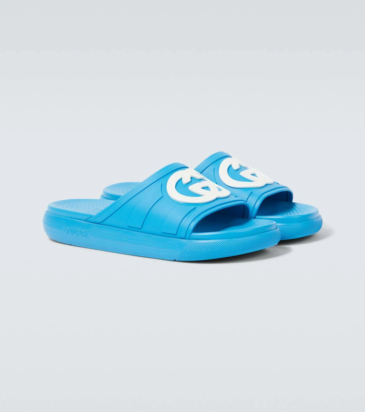 Gucci Pursuit Interlocking G slides in blue with moulded rubber upper and iconic logo for luxury streetwear style.