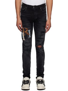 Amiri Leather Staggered Logo Ripped Jeans in Black