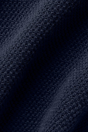 Close-up of textured navy knit fabric used in Tennis Club Sweater Knit Tank, showcasing soft and cozy material.