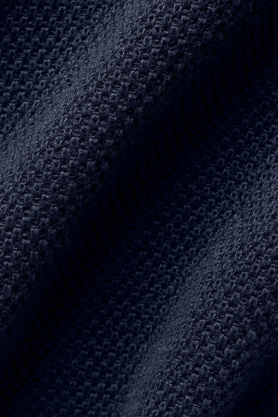 Close-up of textured navy knit fabric used in Tennis Club Sweater Knit Tank, showcasing soft and cozy material.